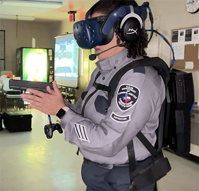 Correctional officer demonstrating a virtual reality gun and headset