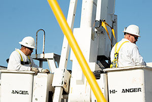 Two inmates in a bucket truck