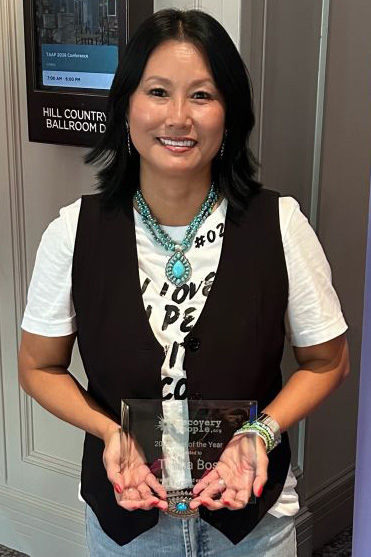Trisha Bos holding her award